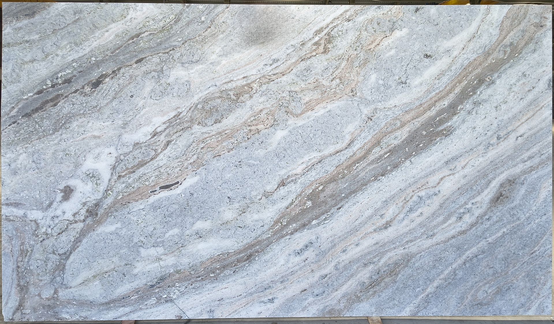 Light gray and beige marble-like stone surface with flowing veined patterns.