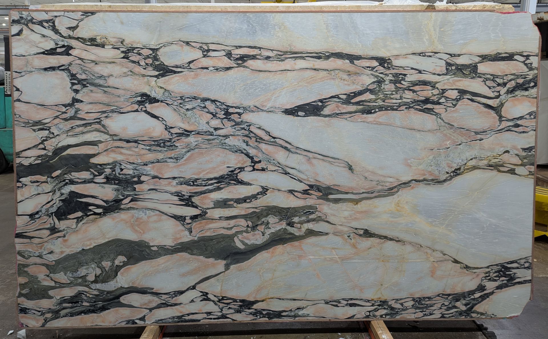 Rectangular slab with cream, beige, and black marbled stone pattern.