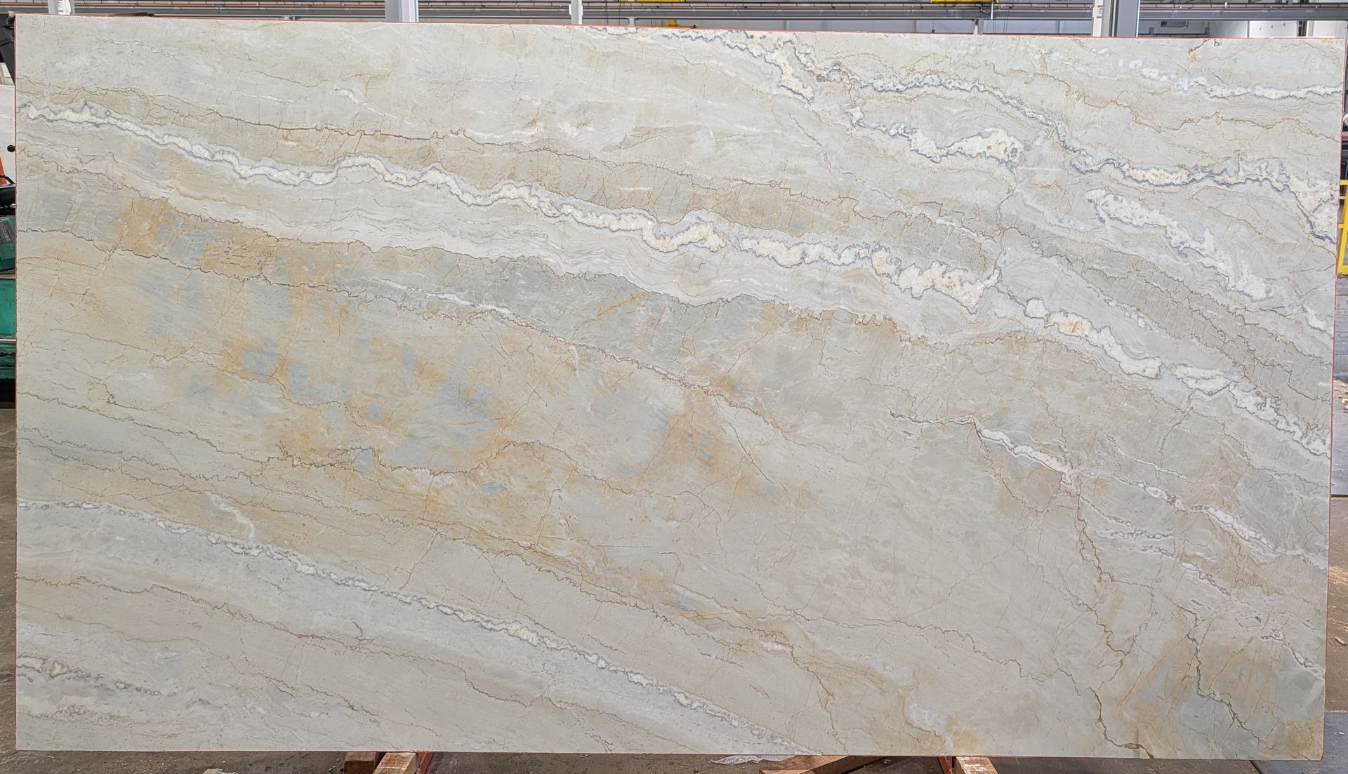 Beige marble slab with subtle gray and tan veining, shown in a rectangular close-up.