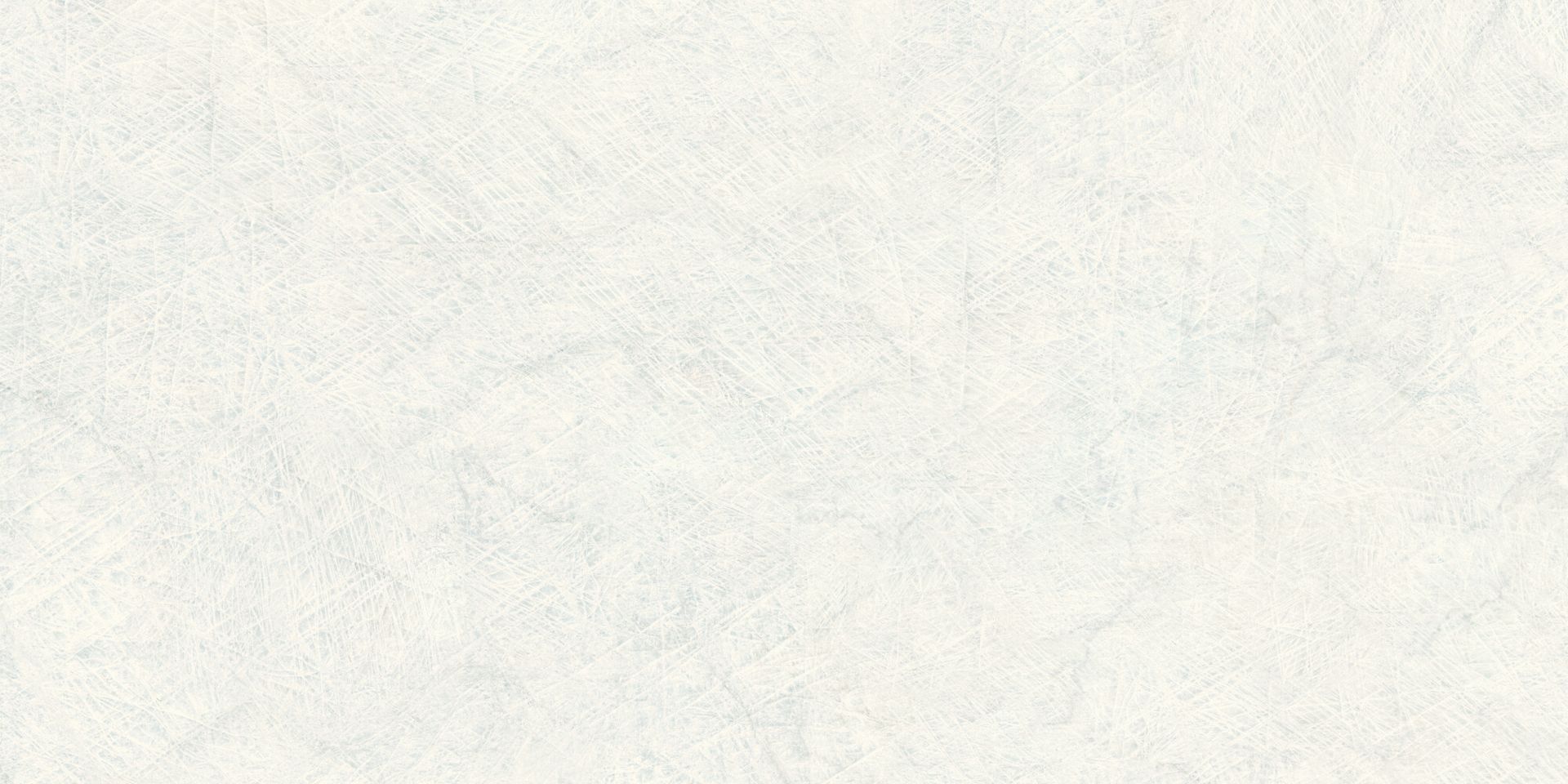 Close-up of a blank, lightly textured off-white surface with faint gray smudges