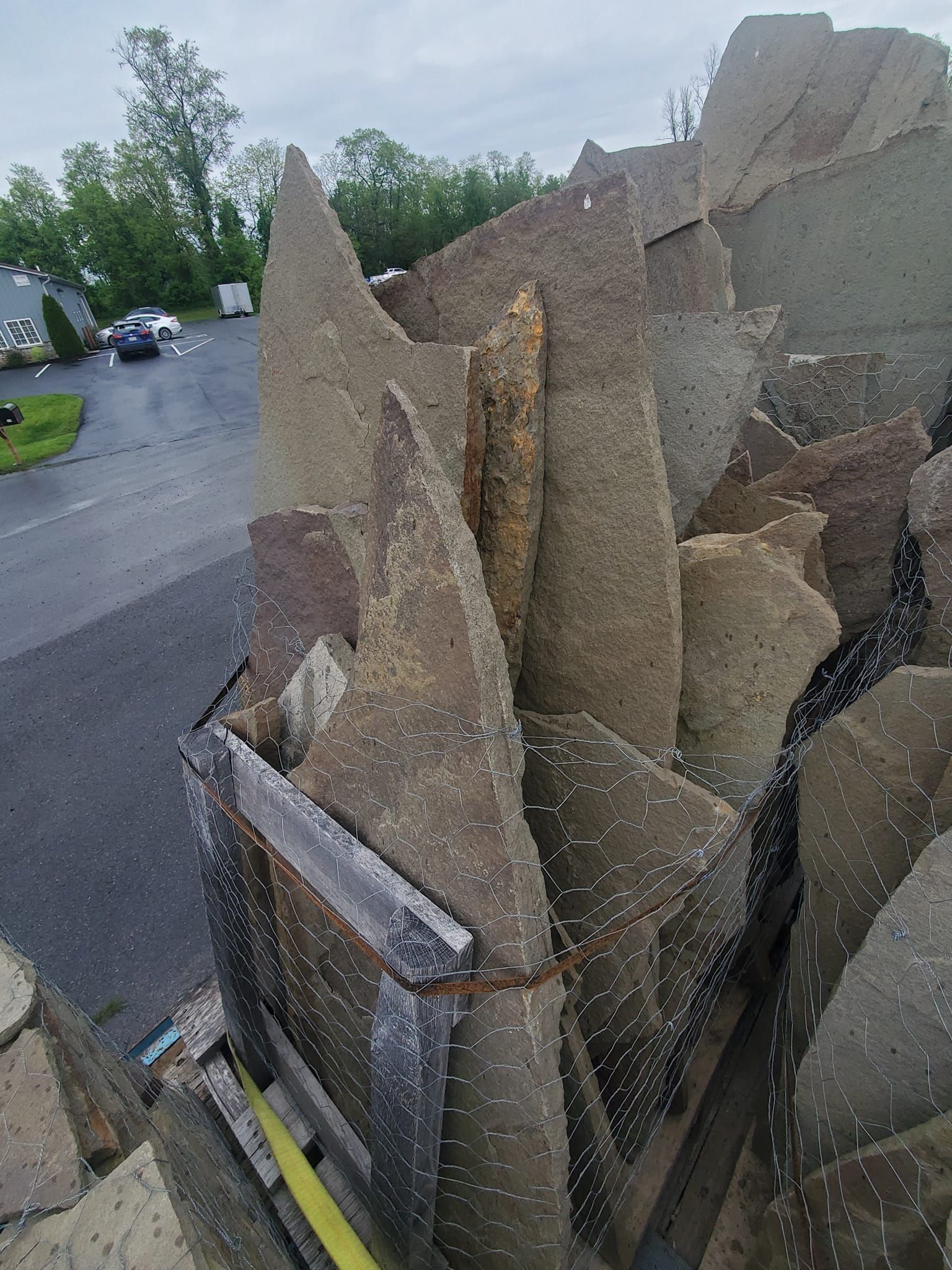 A large pile of rocks is sitting on the side of a road.