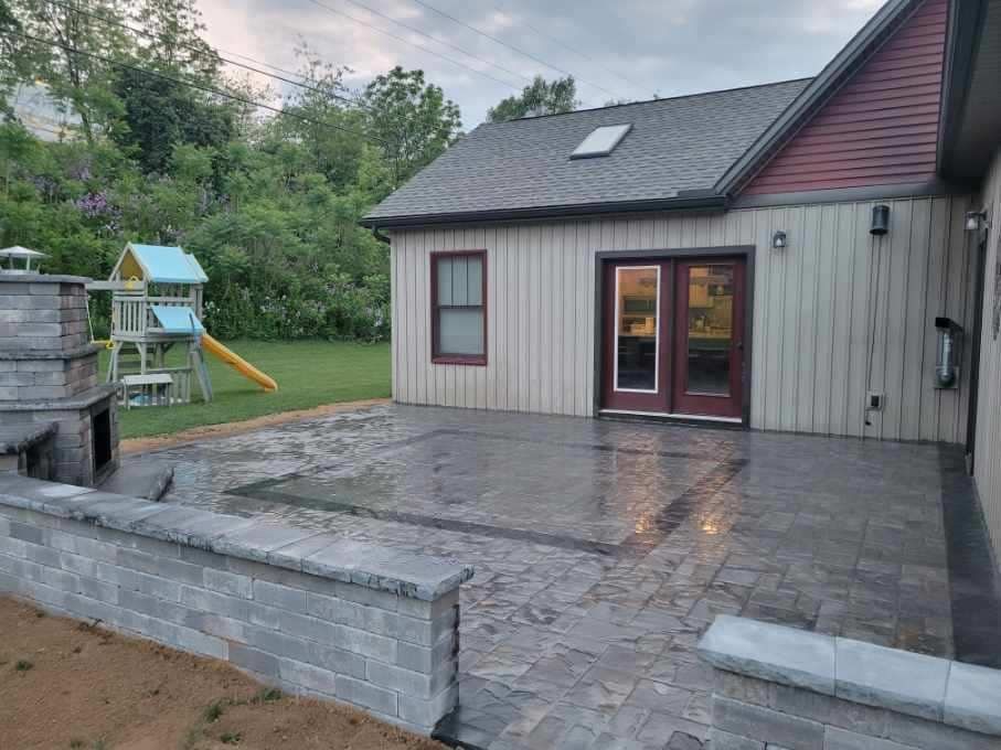 A house with a patio and a playground in the backyard.