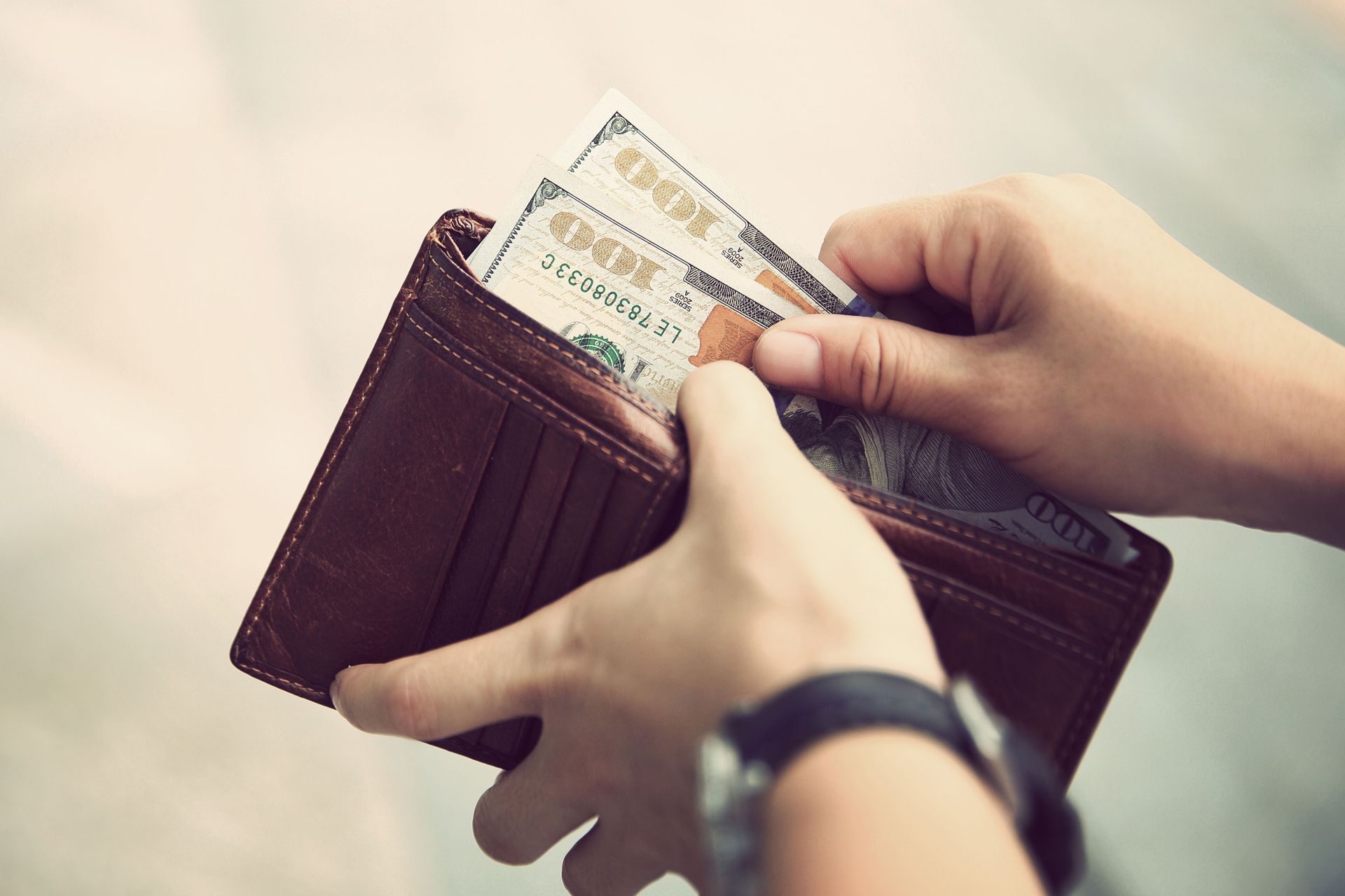 Hands taking out money from wallet