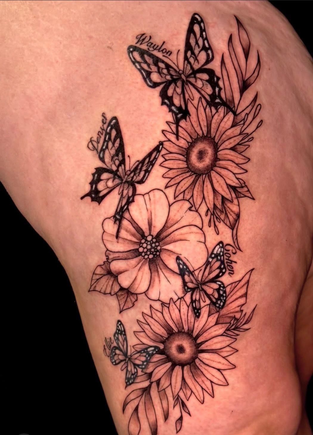 Colorful bird tattoo on lower leg above white sneaker