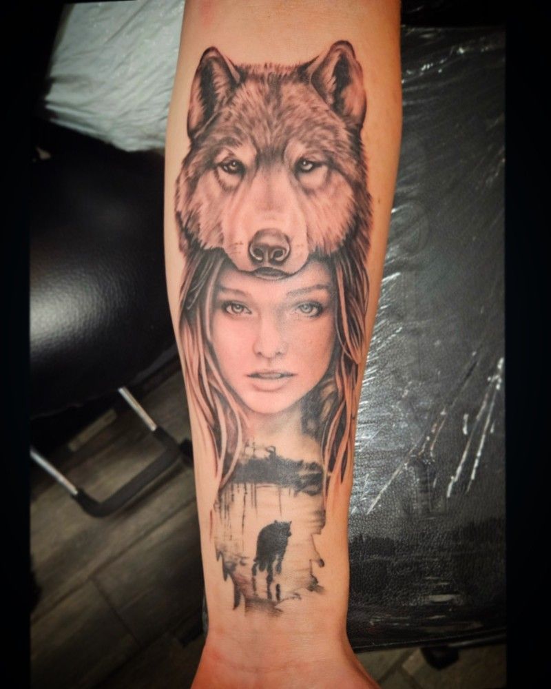 A tattoo of a woman with a wolf on her head
