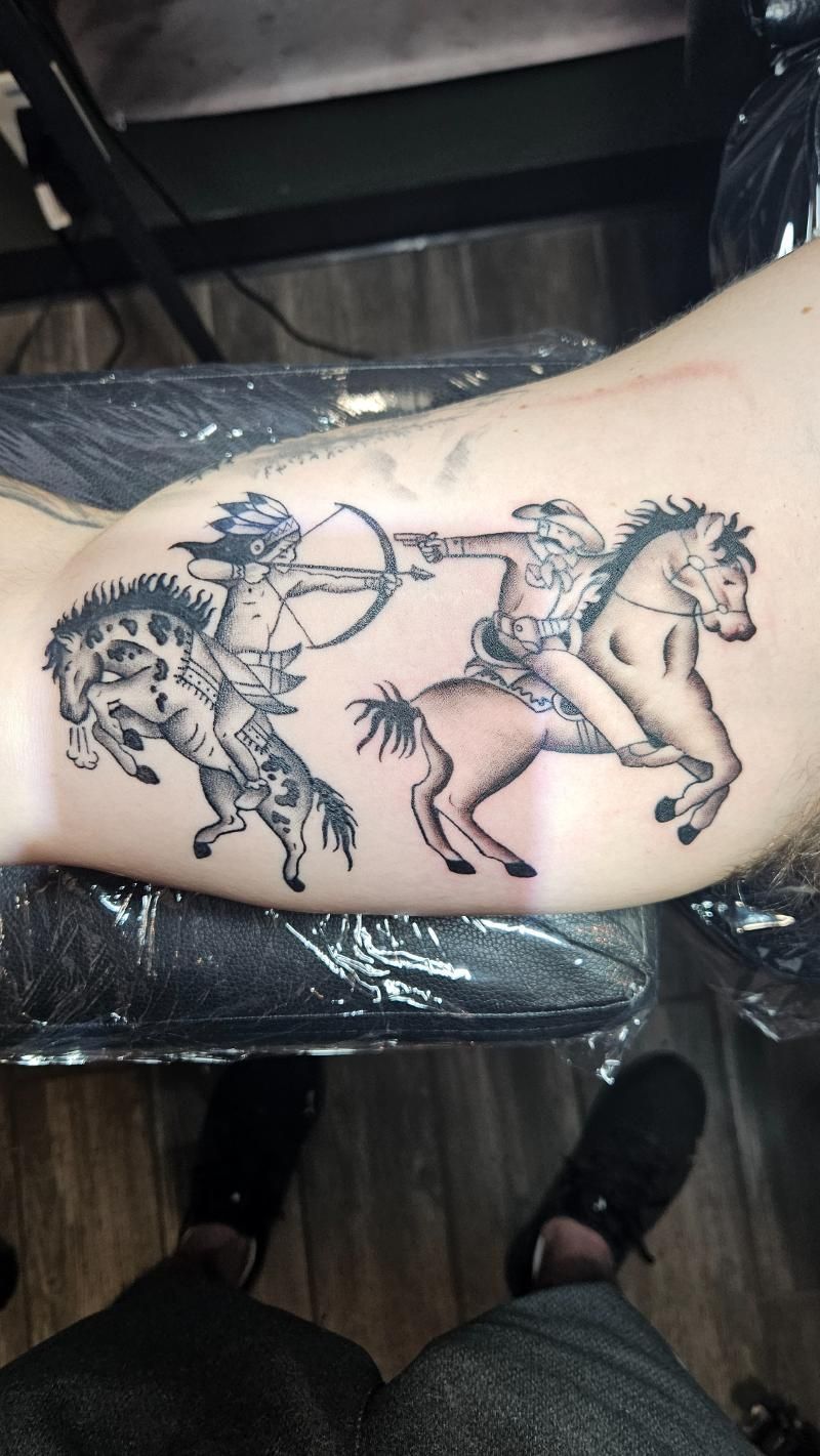 A person has a tattoo of a man riding a horse