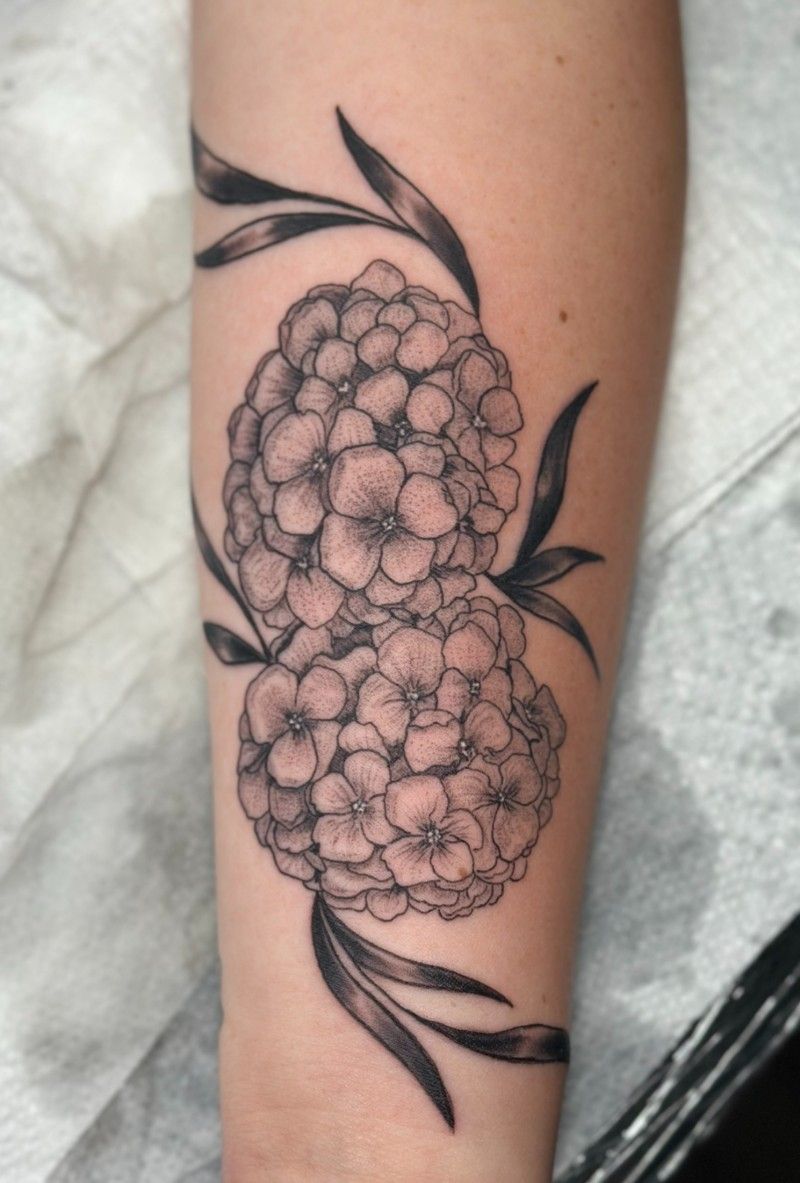 A tattoo of two flowers on a person 's arm