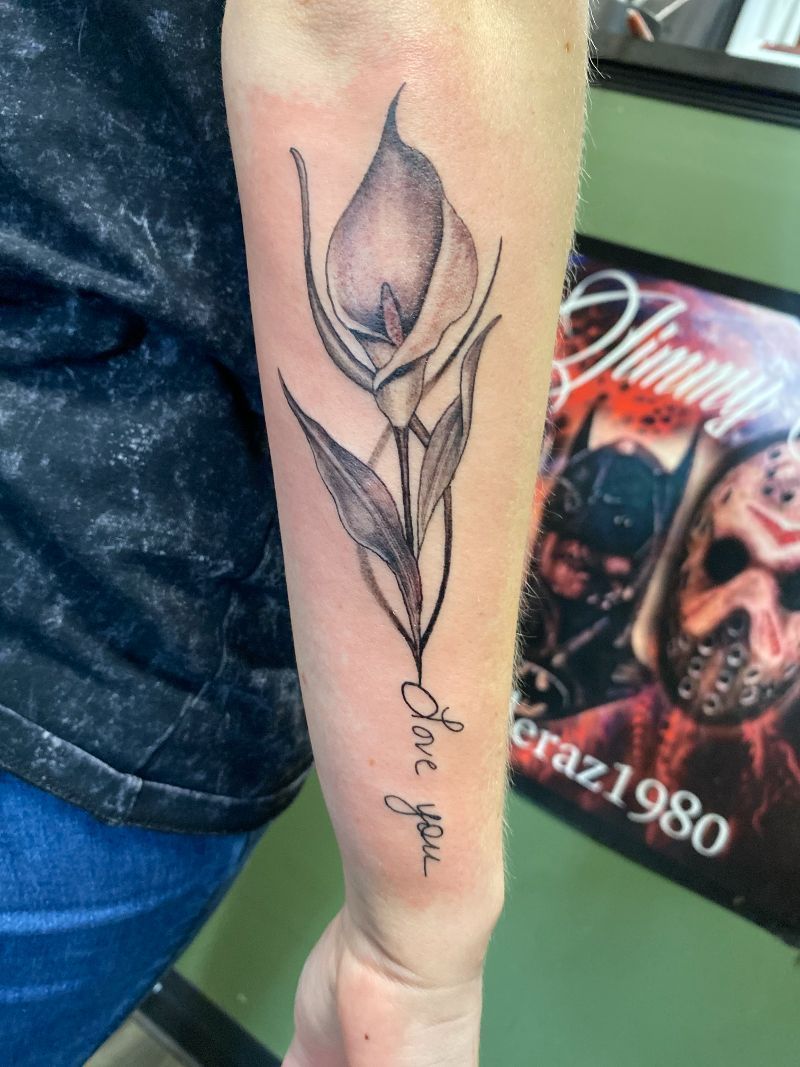 A woman has a tattoo of a flower and the words one you on her forearm