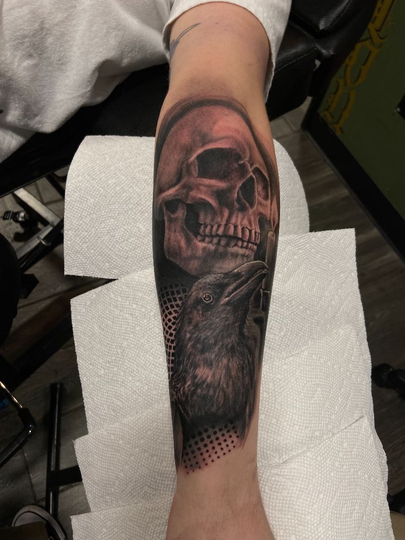 A person has a tattoo of a skull on their forearm.