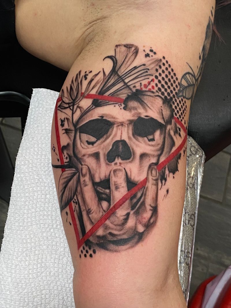 A person has a tattoo of a skull on their arm