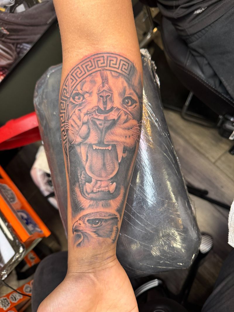 A person has a tattoo of a lion on their forearm.