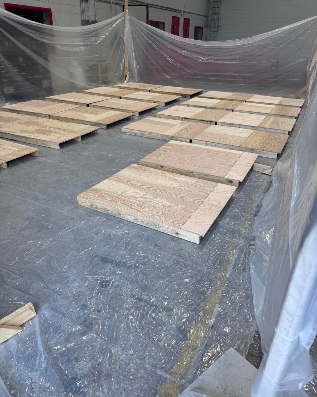 A lot of wooden pallets are laying on the ground