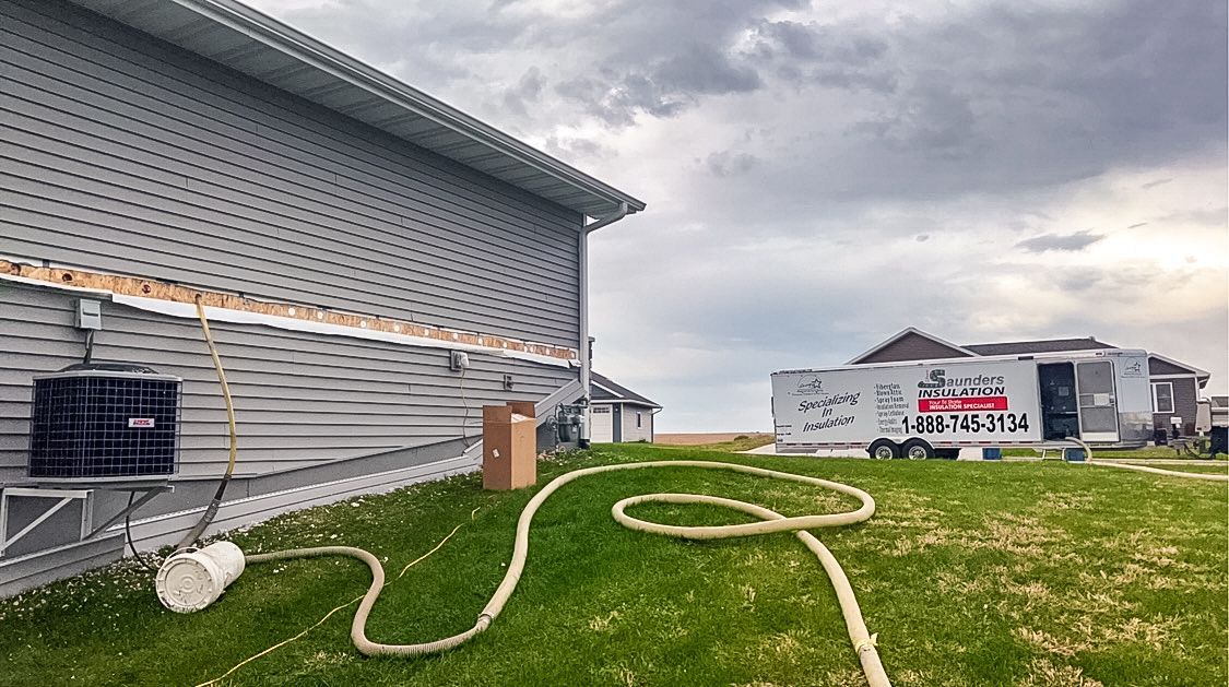 A house with a garage and a trailer parked in front of it.