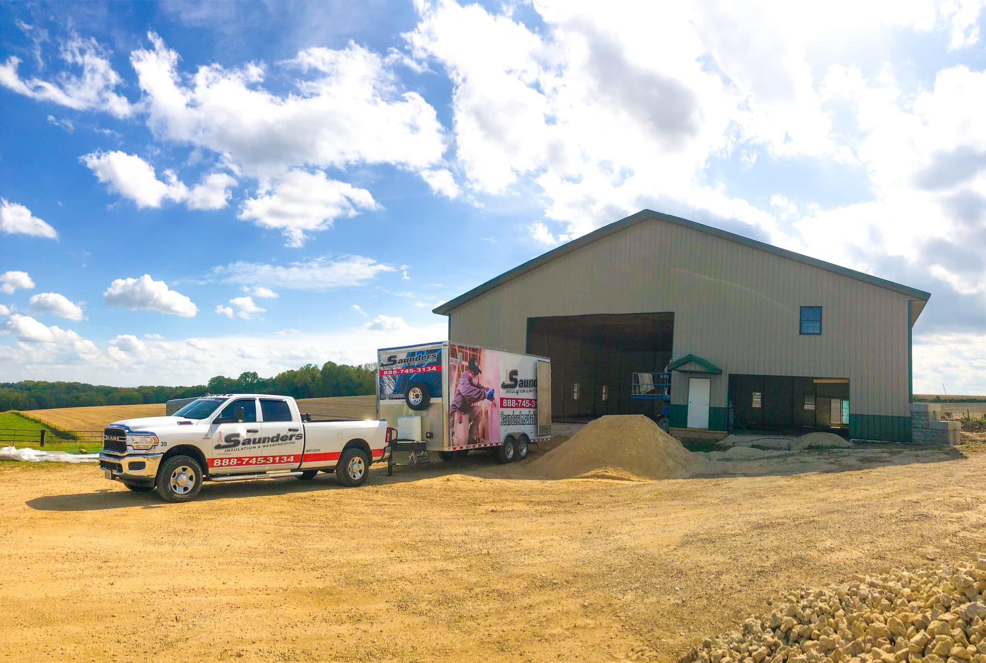 Two trucks are parked in front of a large building.