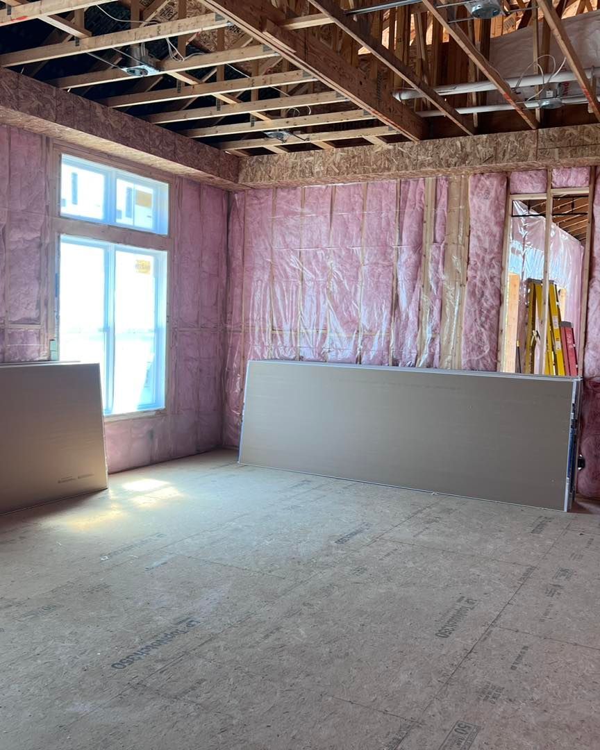 A room with pink insulation on the walls and ceiling.