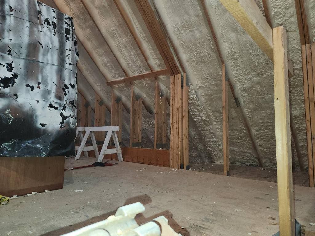 A ladder is sitting in the attic of a house under construction.