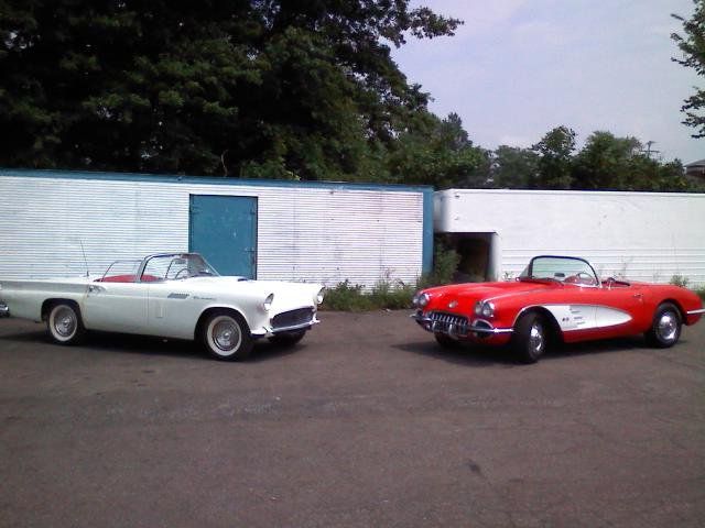 A white car and a red car are parked next to each other