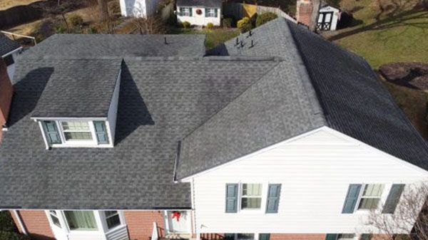 An aerial view of a house with a gray roof.