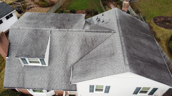 An aerial view of a house with a gray roof.