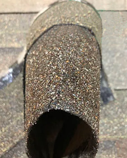 A man is spraying a roof with a hose