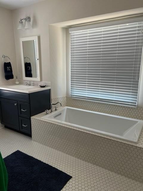 Bathroom tub with black cabinet on the side