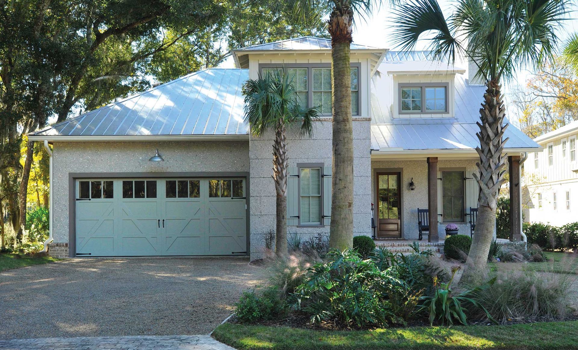 A house with a blue roof and a white garage door