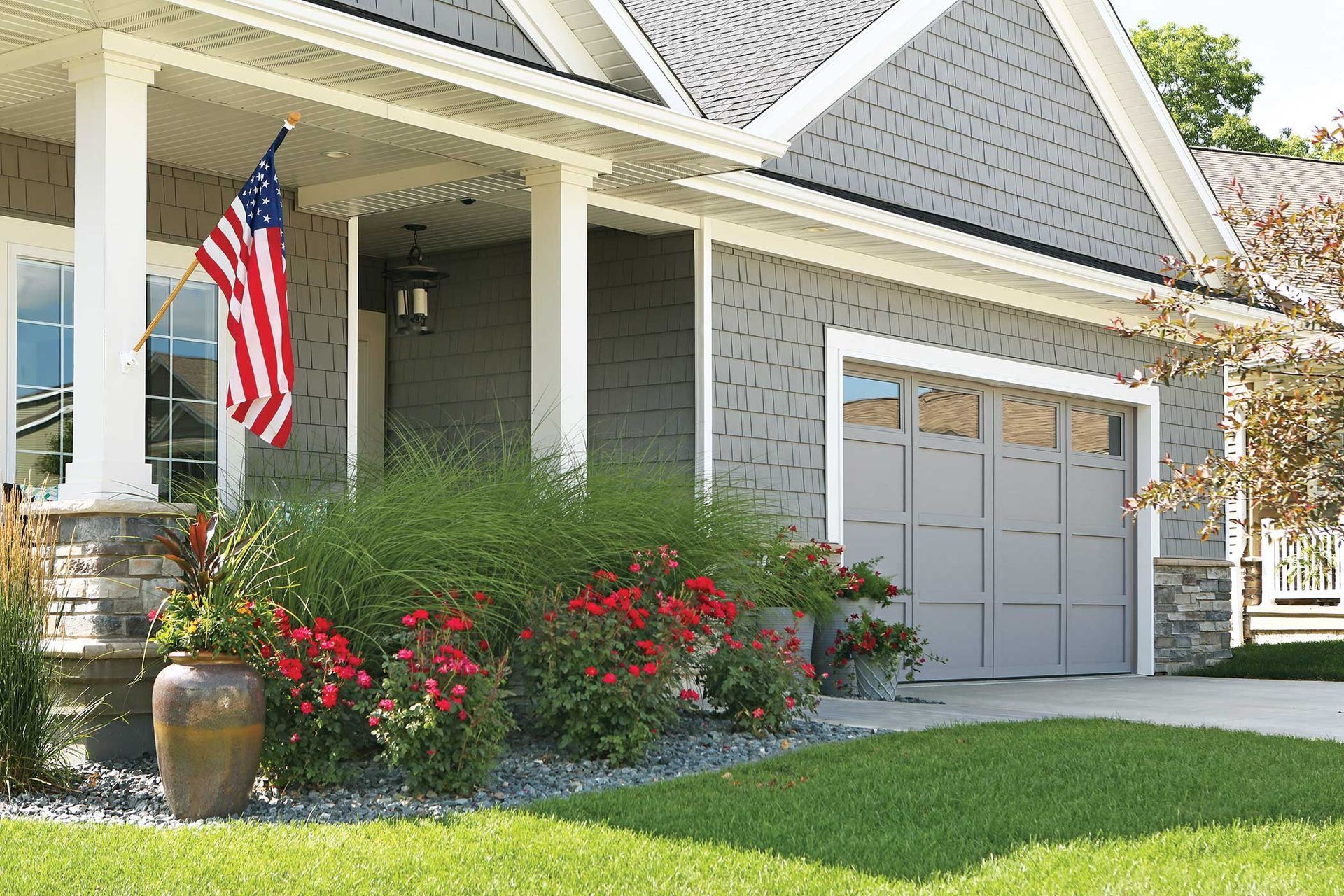 A house with an american flag on the front porch.