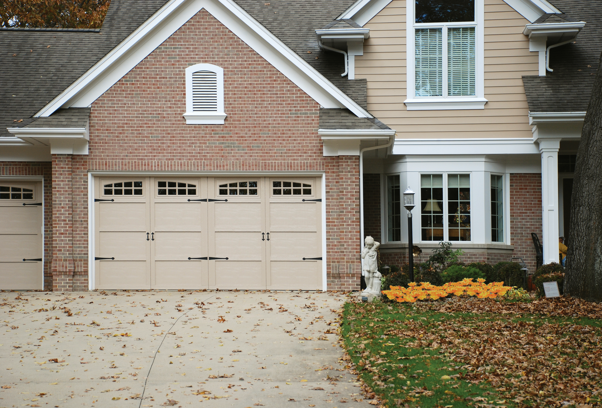 A large brick house with a white garage door