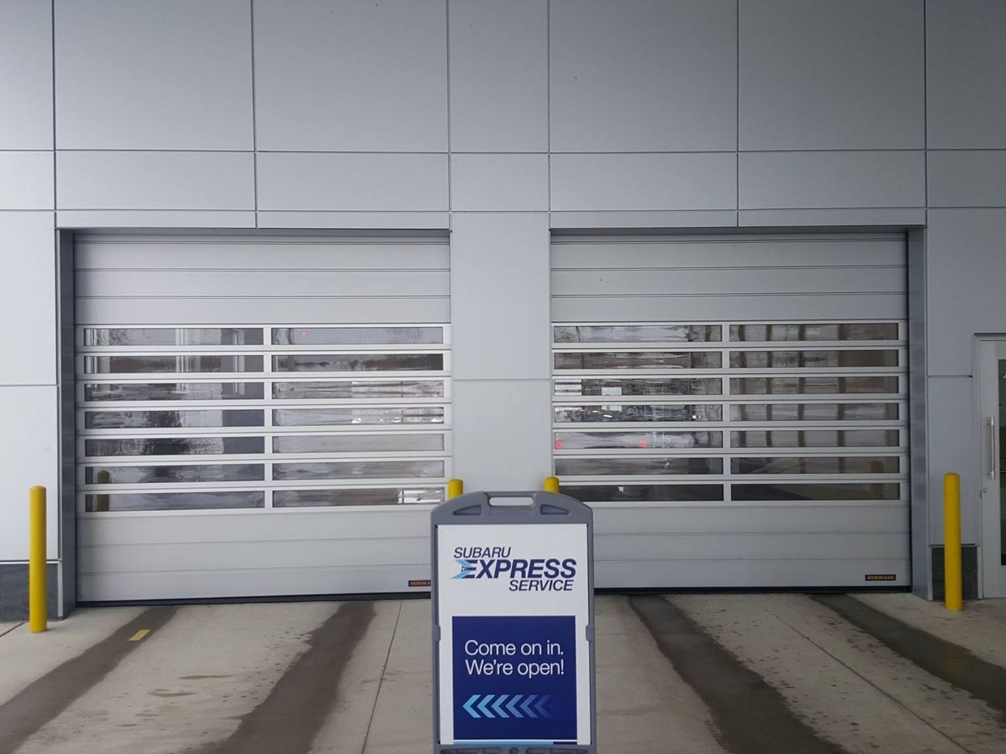A large garage door with a sign in front of it that says toyota express service