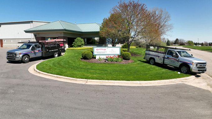 Two trucks are parked in front of a building.