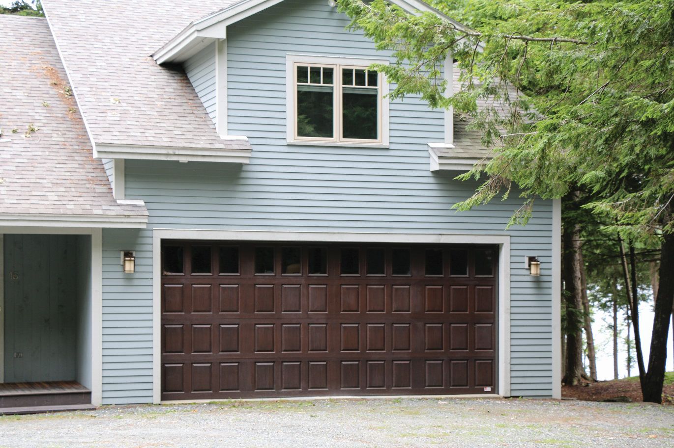 A blue house with a brown garage door