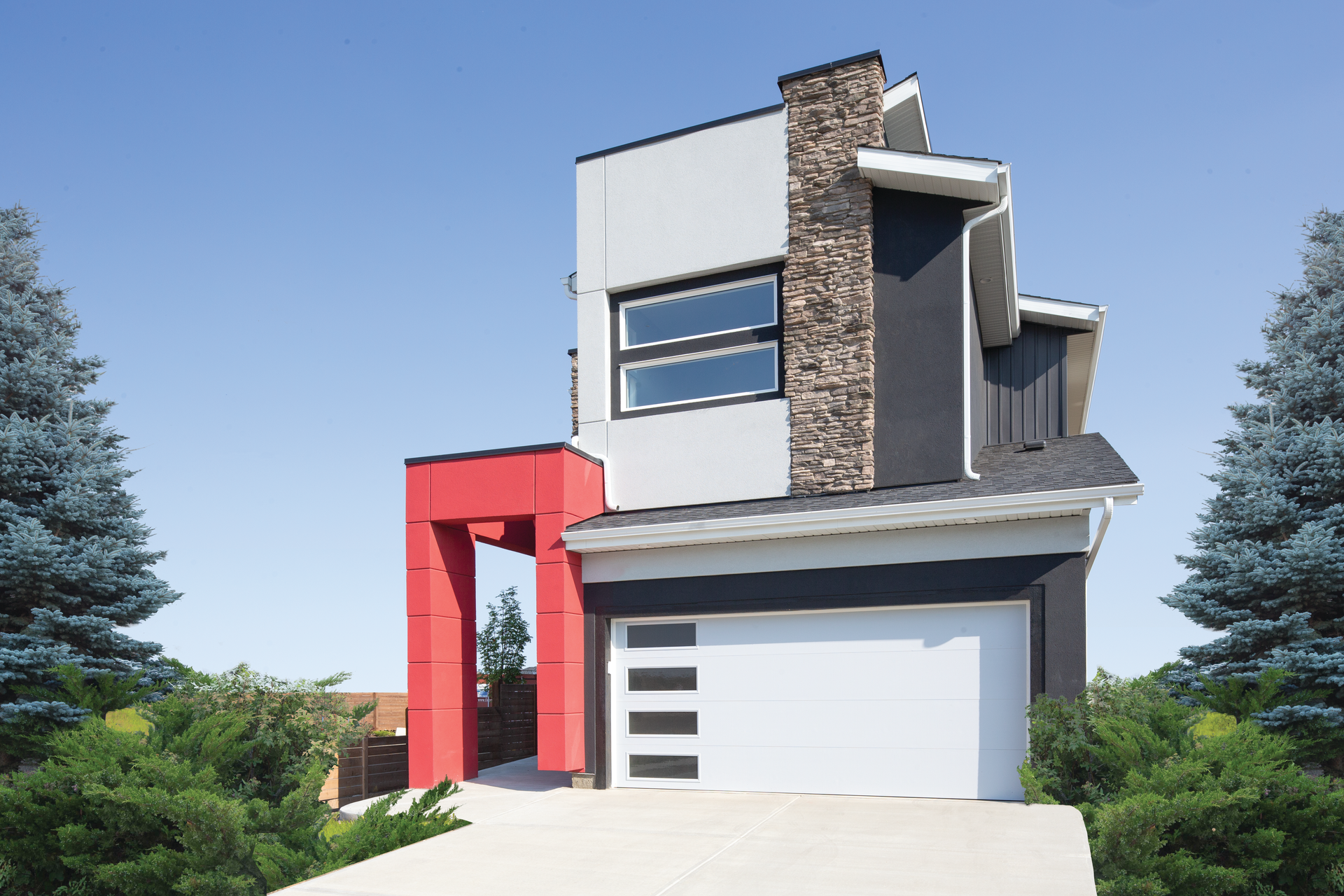 A black and red house with a white garage door