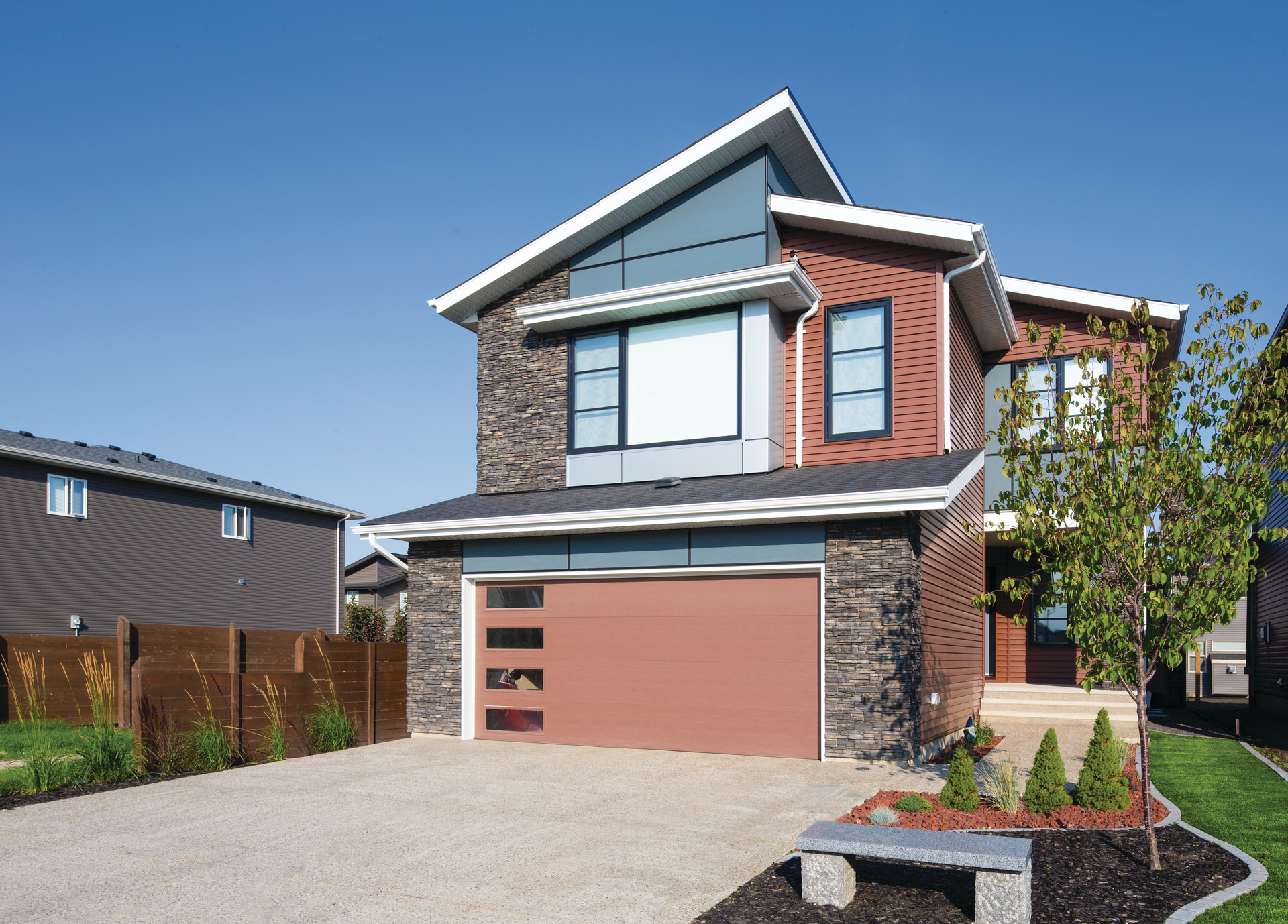 A large brick house with a red garage door