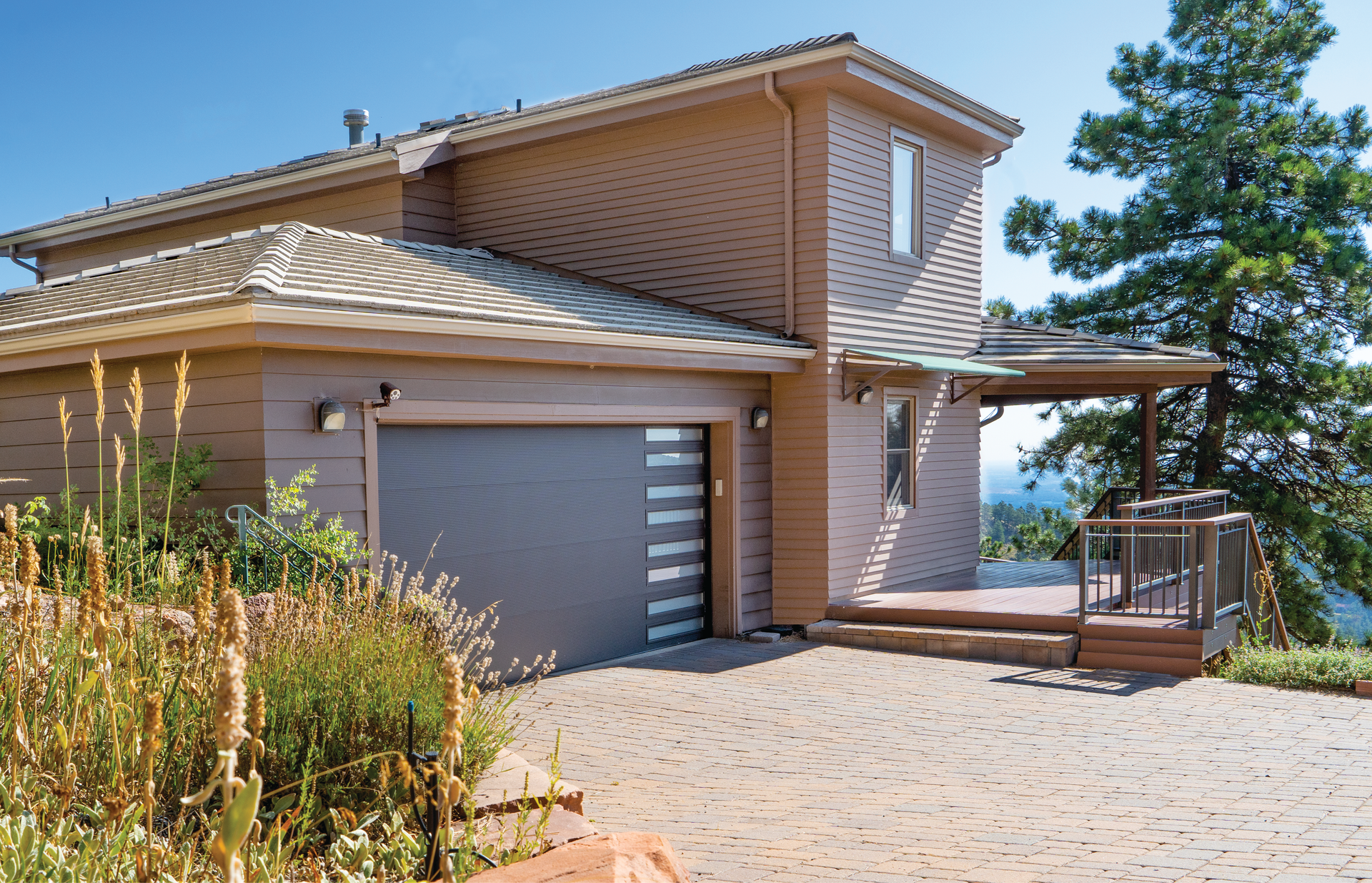 A house with a gray garage door and a porch