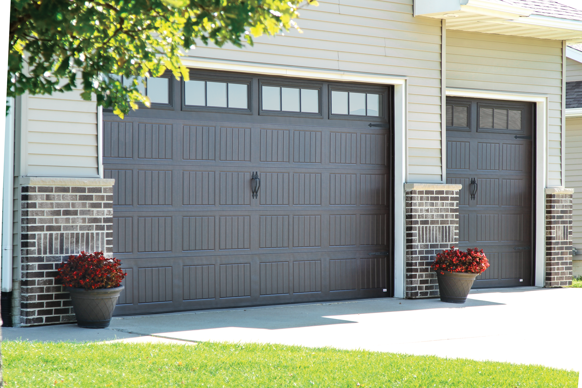 A couple of garage doors with flowers in front of them