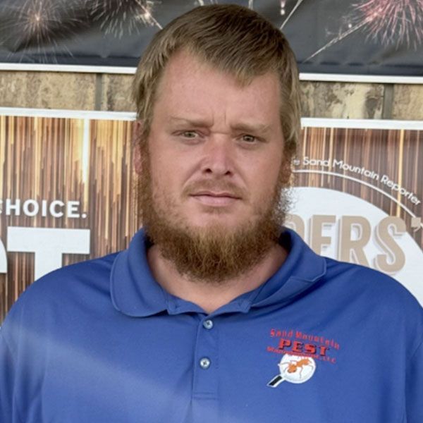 Man with beard wearing a blue polo shirt with 
