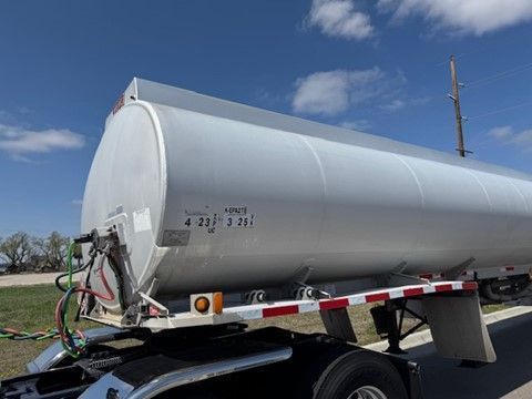 A large tanker truck is parked on the side of the road.