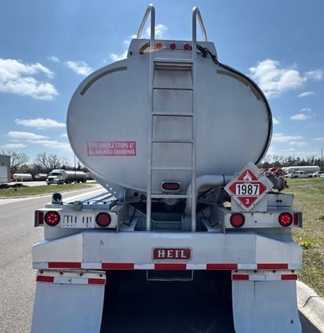 A tanker truck is parked on the side of the road.