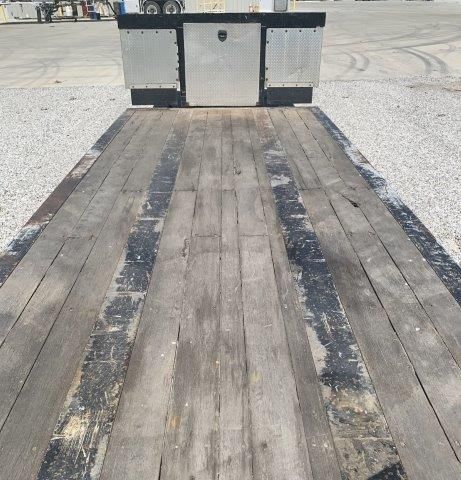 The back of a trailer with a wooden deck.