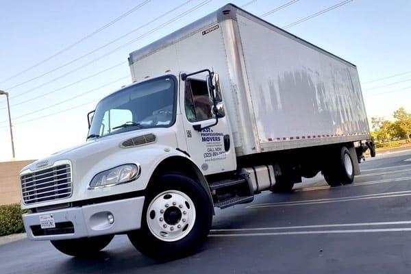 White moving truck parked on asphalt.