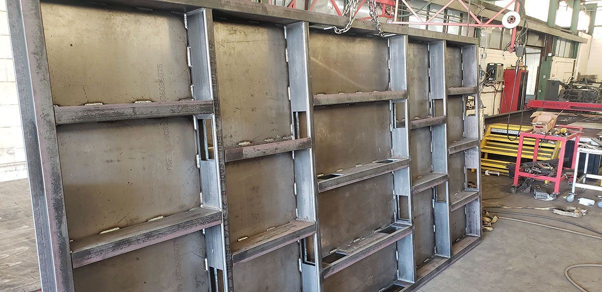 A large metal wall is sitting in a warehouse.