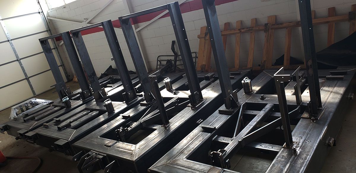 Metal pieces are stacked in a room.