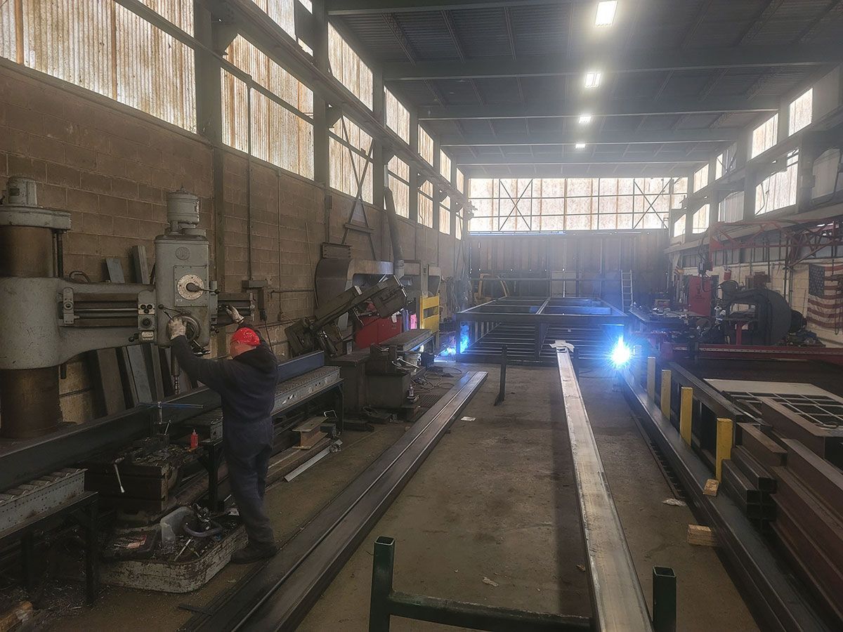 A man is working on a machine in a factory.