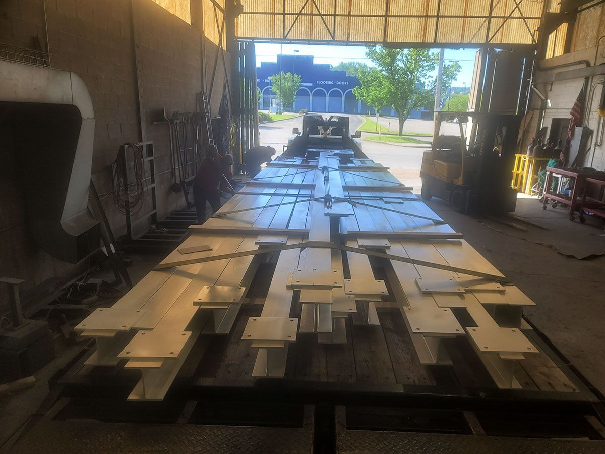 A large piece of metal is sitting on top of a table in a garage.