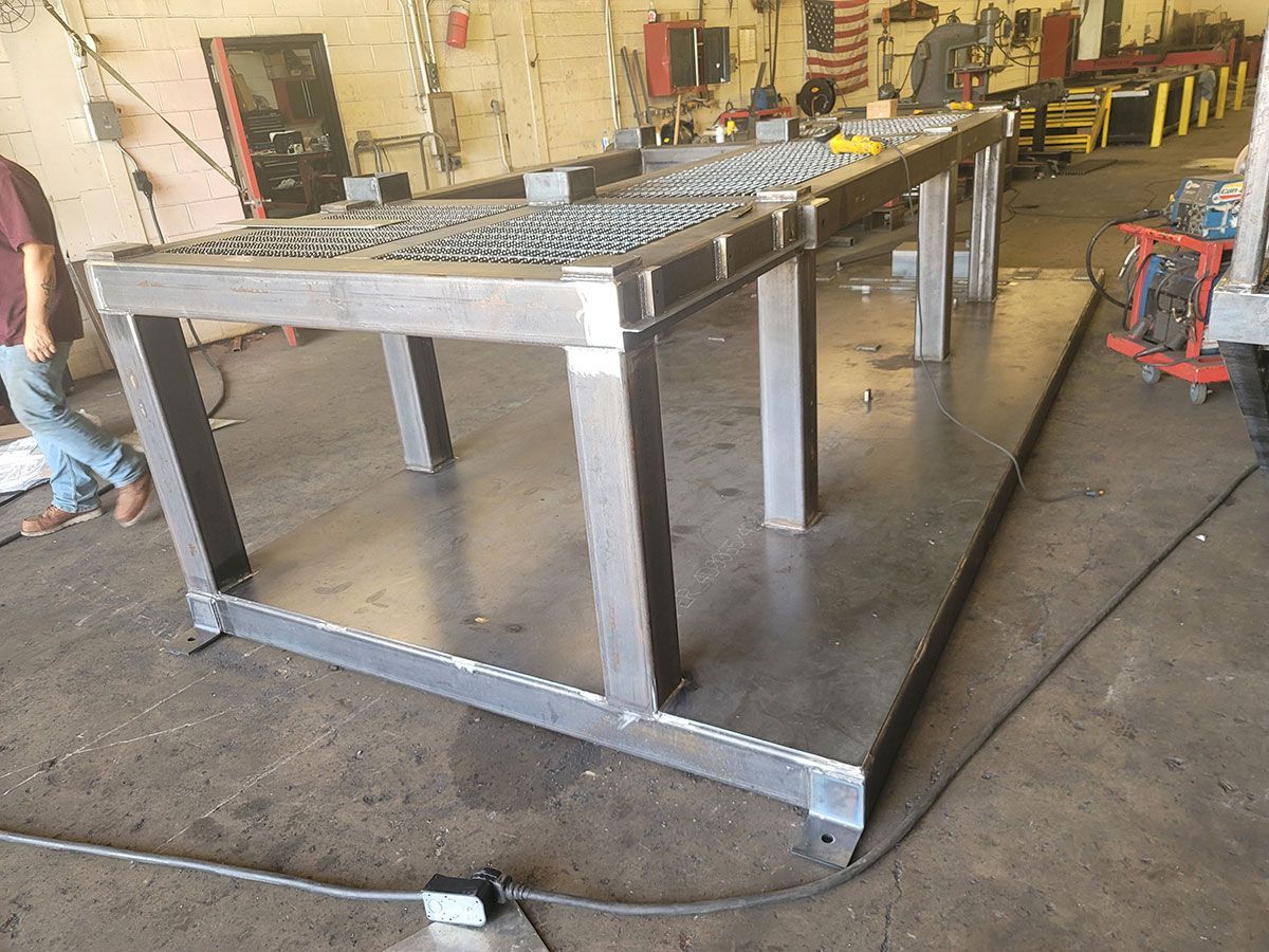 A metal table is being built in a factory.