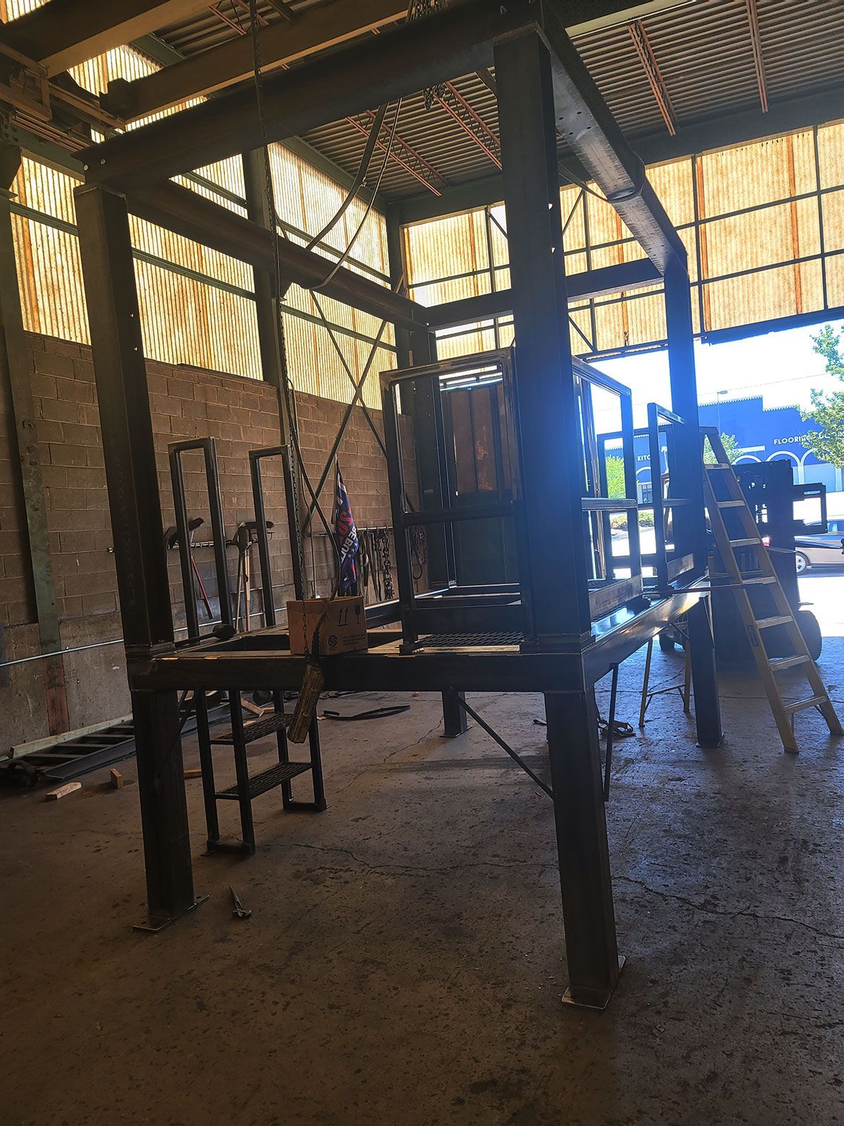 A large metal structure is sitting inside a building.