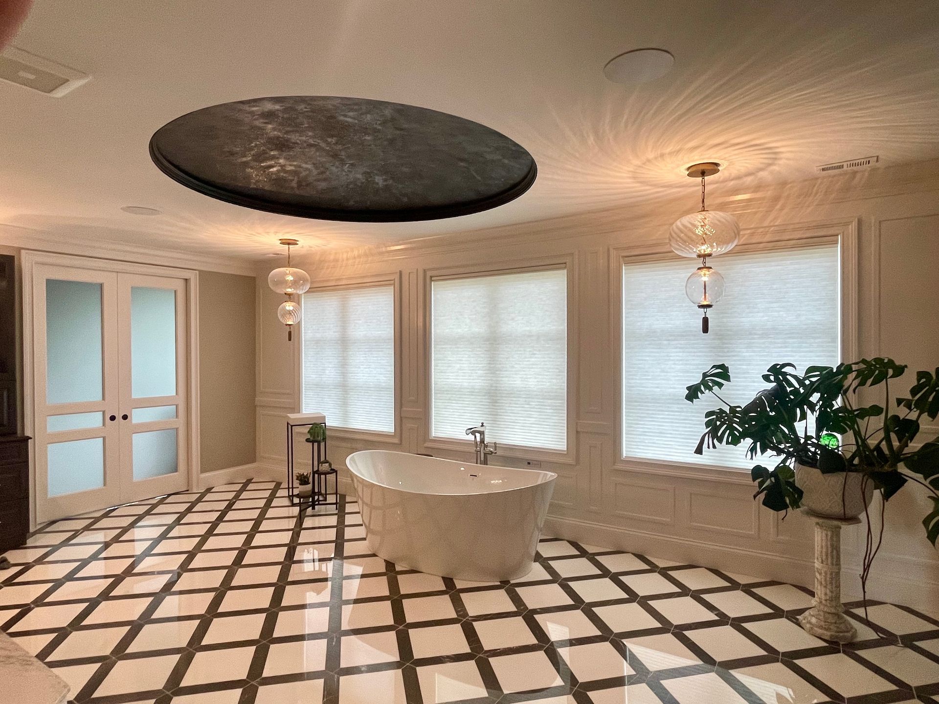 A bathroom with a bathtub and a plant in it.
