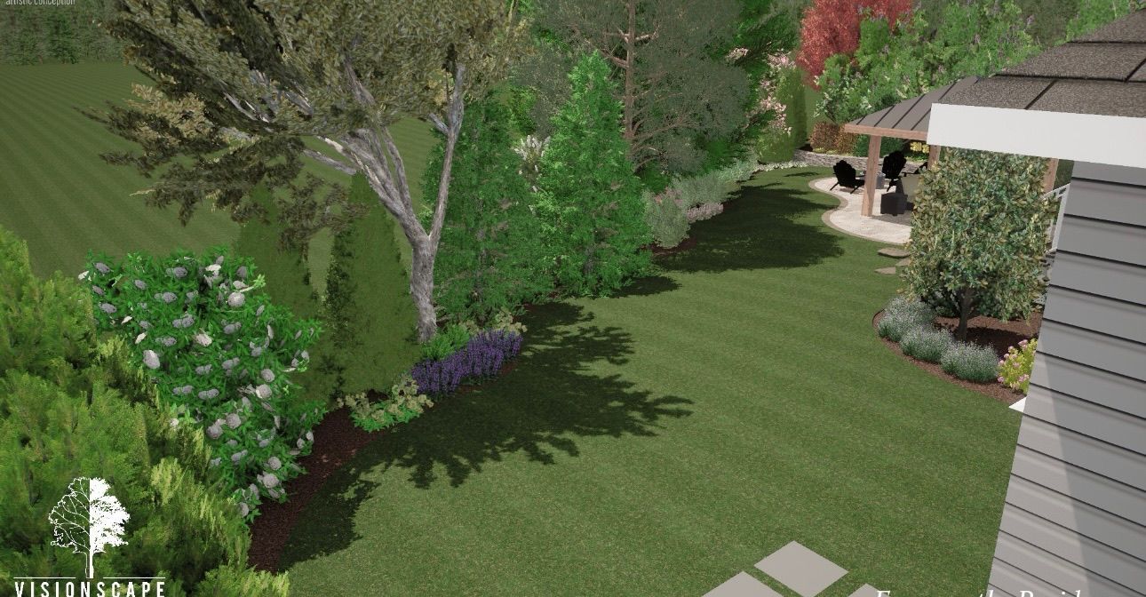 Landscaped backyard with green lawn, trees, purple flowers, and a house patio in the background
