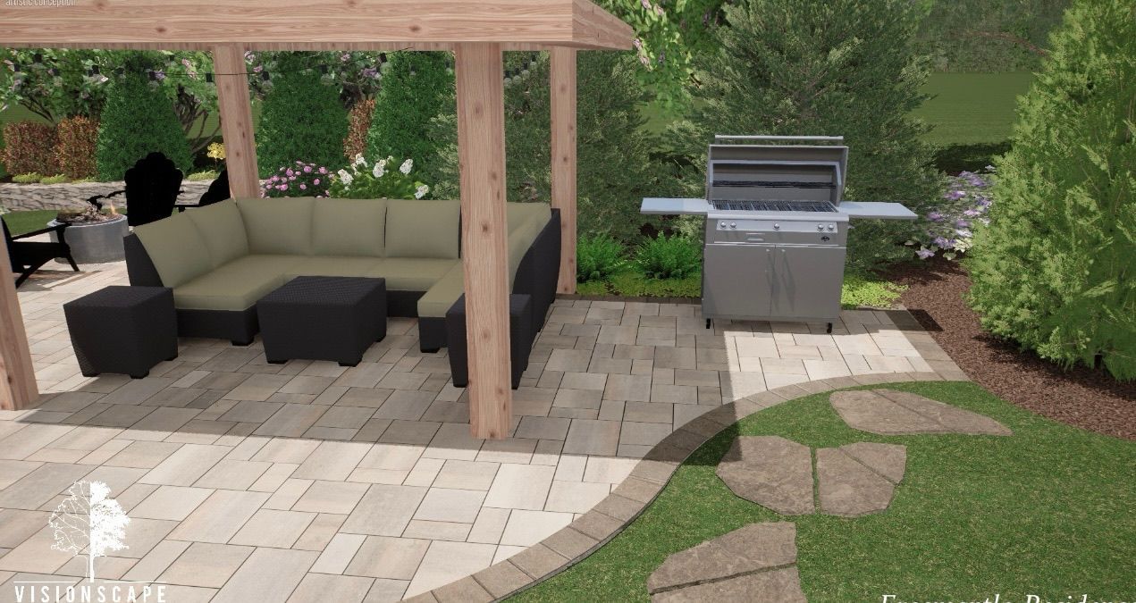 Covered patio with outdoor seating and a built-in grill beside a stone paver patio and lawn