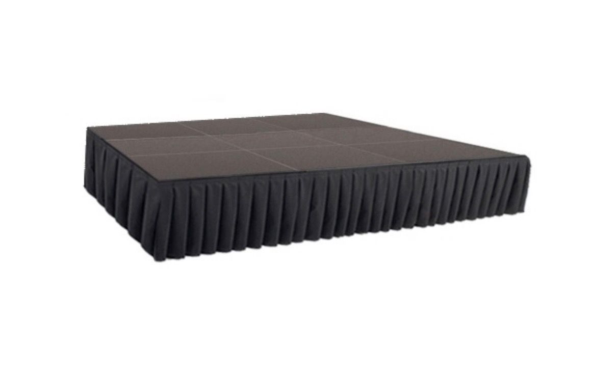 Black rectangular stage riser with pleated skirt on a white background